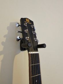 Wall-mounted guitar holder