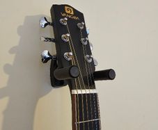 Wall-mounted guitar holder