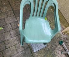 Pair of green plastic garden chairs