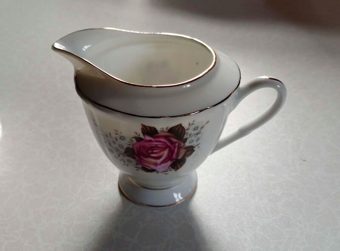 Milk Jug & 4 Saucers (used).