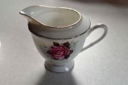 Milk Jug &amp; 4 Saucers (used).