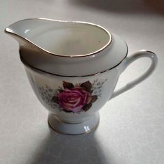 Milk Jug & 4 Saucers (used).