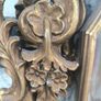 large, ornate gold mirror features a baroque frame Image 6