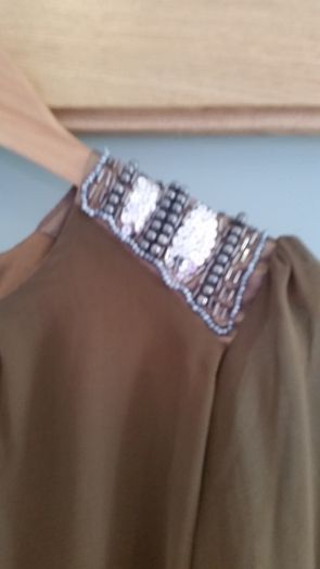 Brand New. Chiffon top with sequined shoulders