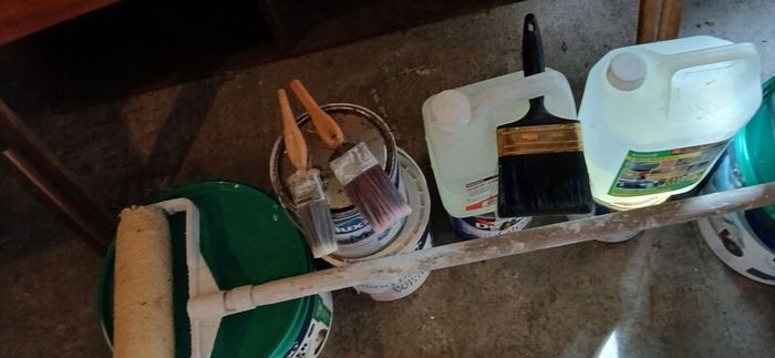 a selection of paint and a paint roller and some good paint brushes