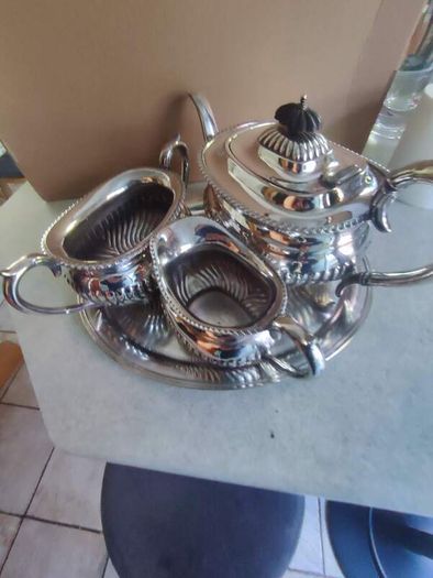 Vintage from the 19th century. Antique Period English Tea Service inc Teapot, Sugar bowl & milk jug Sheffield England on small silver plated tray.