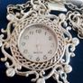 Ladies Quartz Necklace Watch with Filigree Design on Casing and Surrounded by 8 White-Silver Diamante Stones. Image 3