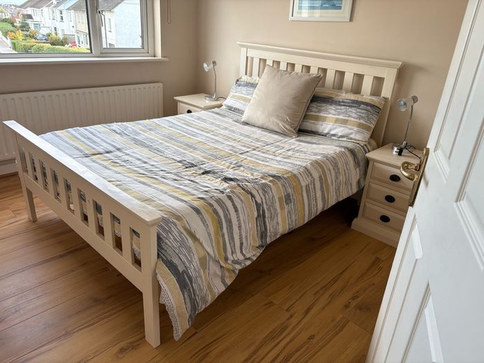 Cream wooden double bed