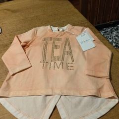 This is a Gaialuna peach-colored long-sleeve top featuring "FREE TIME" embellished in studs on the front. New with tags..