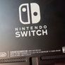 Nintendo Switch with original case and Anker adapter. Image 3