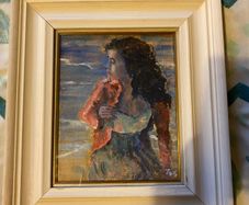 painting This is an atmospheric portrait depicting a woman standing on a coastal shore at dusk or twilight, clutching a reddish-pink wrap or cardigan around her shoulders.