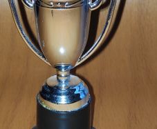 Silver tone mini trophy cup with winged handles, H 10 cm