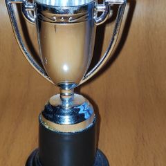 Silver tone mini trophy cup with winged handles, H 10 cm