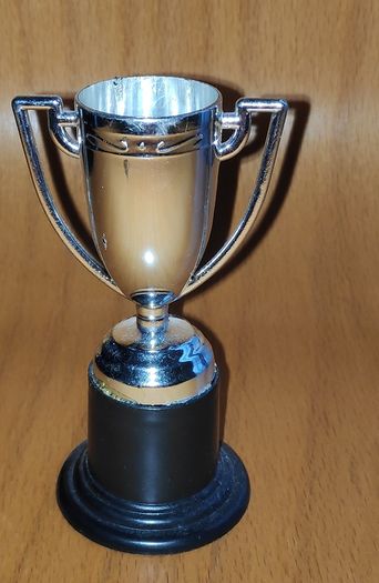Silver tone mini trophy cup with winged handles, H 10 cm