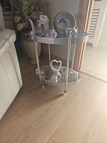 drinks trolly and large flower arrangement with vase