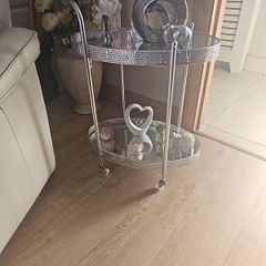 drinks trolly and large flower arrangement with vase