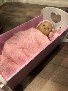Doll crib with a baby