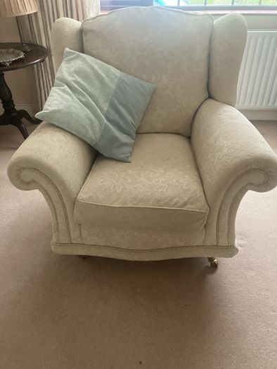 Cream armchair on brass caster