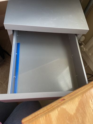 Grey lockable filing cabinet on castors