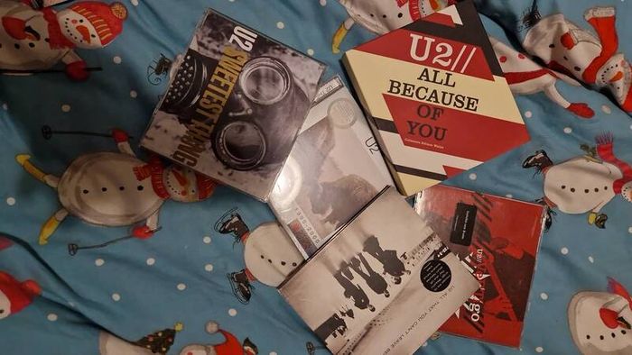 bag of U2 promo CD singles, CD albums and DVD sets