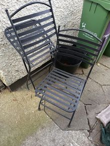 Two metal balcony chairs.