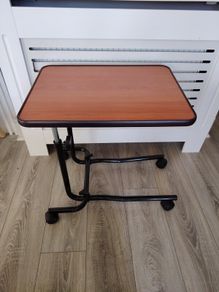 Adjustable over bed table on wheels