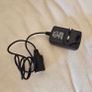 AC/DC power adapter (Model: 1220) that converts household AC mains power (100-240V) into a 12V DC cigarette  lighter socket. Image 2