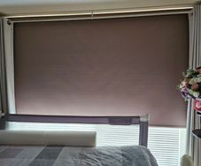 Beige Blackout roller blind with a white control chain