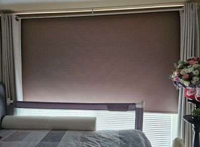 Beige Blackout roller blind with a white control chain