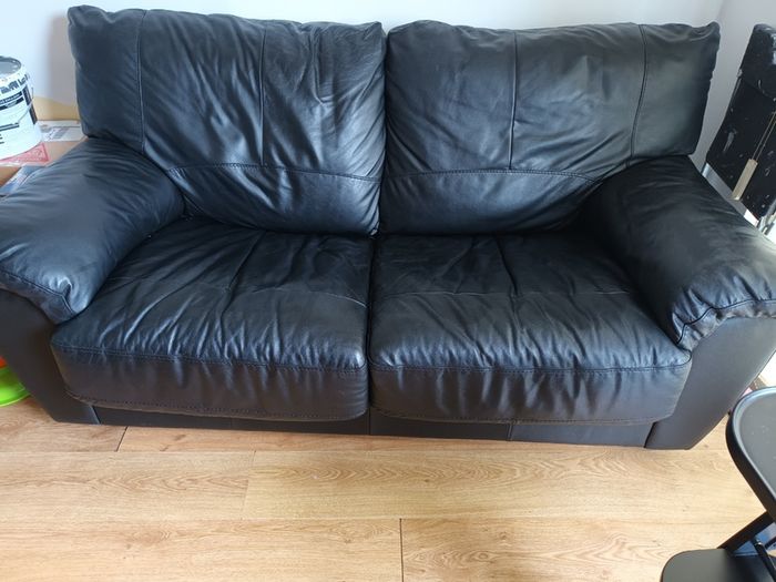 Black leather two-seater sofa-bed