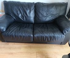 Black leather two-seater sofa-bed