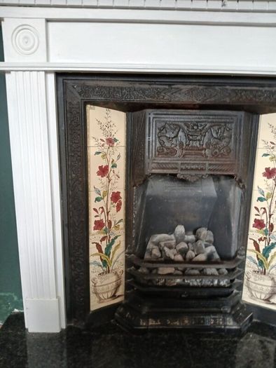 Fireplace in cast iron with wooden surround (painted white) and black marble hearth.   Perfect condition