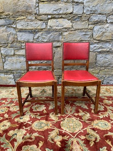 A pair of mid century leatherette kitchen chairs.