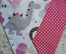 Dinosaur buntings . Blue and pink