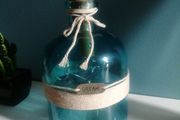 teal glass bottle with lights