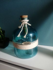 teal glass bottle with lights