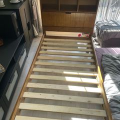 single wooden bed with storage headboard and matress