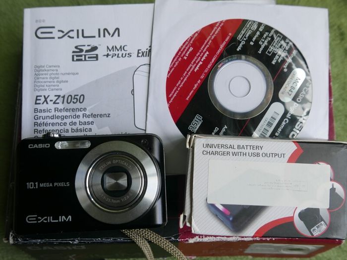 Casio Exilim EX-Z1050 Digital camera Made w/ Box and Accessories , universal charger- Tested