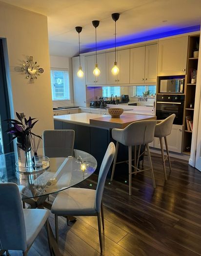 4 beige dining chairs and 2 counter stools