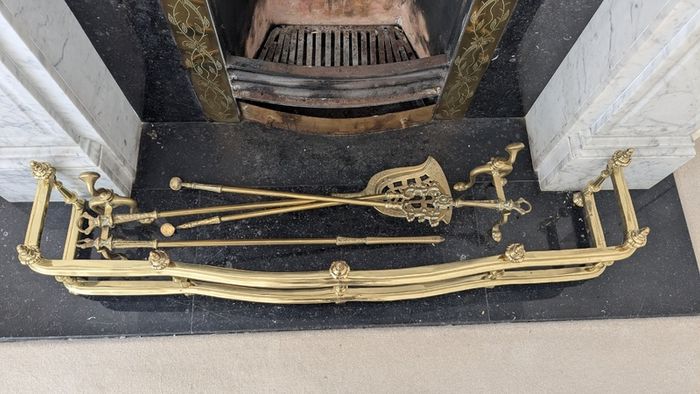Brass fireplace fender and companion set