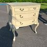 Vintage Olympus cream and gilt Louis style chest of drawers featuring bow-front drawers and cabriole legs. Image 2