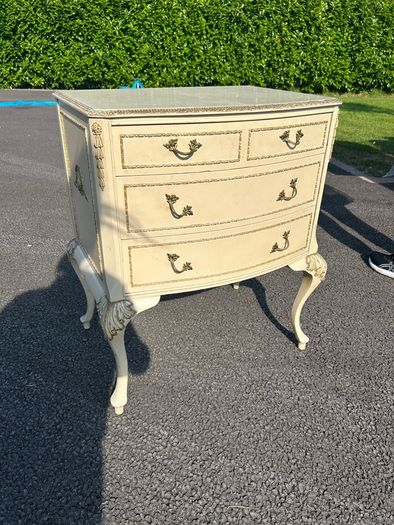 Vintage Olympus cream and gilt Louis style chest of drawers featuring bow-front drawers and cabriole legs.
