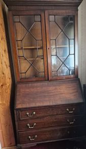 antique wooden bureau bookcase, likely an Edwardian or late Georgian mahogany piece featuring a glazed upper cabinet and a drop-front desk above lower drawers