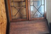 Needs to go this week.....any resonable offers accepted antique wooden bureau bookcase, likely an Edwardian or late Georgian mahogany piece featuring a glazed upper cabinet and a drop-front desk above lower drawers