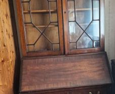 antique wooden bureau bookcase, likely an Edwardian or late Georgian mahogany piece featuring a glazed upper cabinet and a drop-front desk above lower drawers