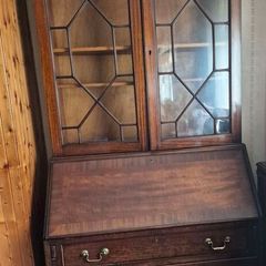 antique wooden bureau bookcase, likely an Edwardian or late Georgian mahogany piece featuring a glazed upper cabinet and a drop-front desk above lower drawers