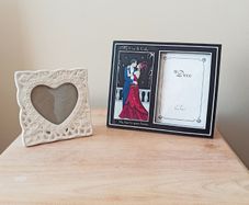 Two freestanding glazed photo frames;  white ceramic heart-shaped picture frame &  Art Deco style dual picture frame