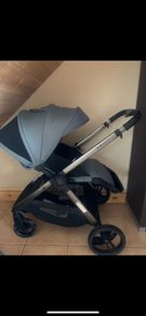 Sage green buggie with rain cover.