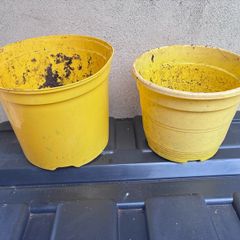 2 yellow plastic flower pots