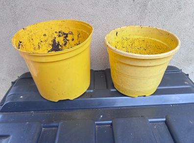 2 yellow plastic flower pots